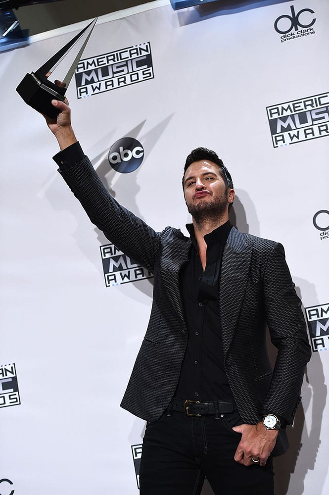 Luke Bryan, winner of the award for favorite country male artist, poses in the press room at the 42nd annual American Music Awards at Nokia Theatre L.A.