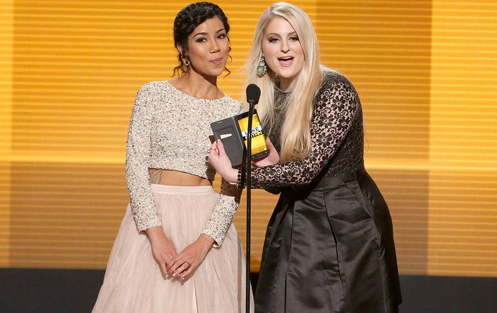 Jhene Aiko, left, and Meghan Trainor present the award for favorite country male artist to Luke Bryan at the 42nd annual American Music Awards at Nokia Theatre L.A. 