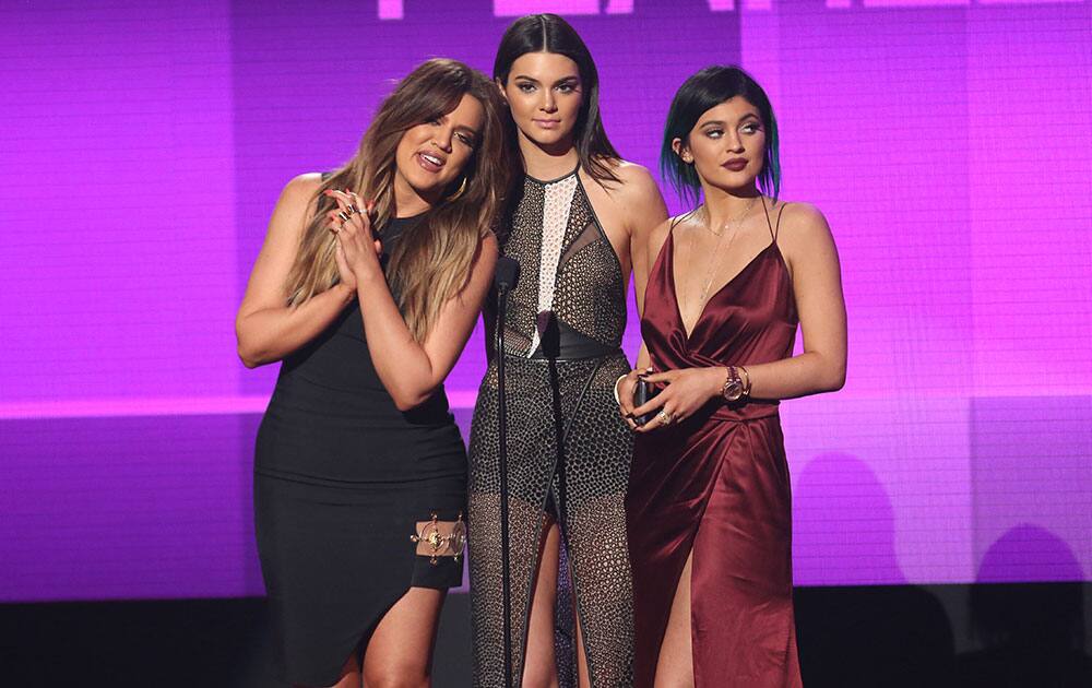 Khloe Kardashian, from left, Kendall Jenner and Kylie Jenner present the award for favorite pop/rock female artist on stage at the 42nd annual American Music Awards at Nokia Theatre L.A.