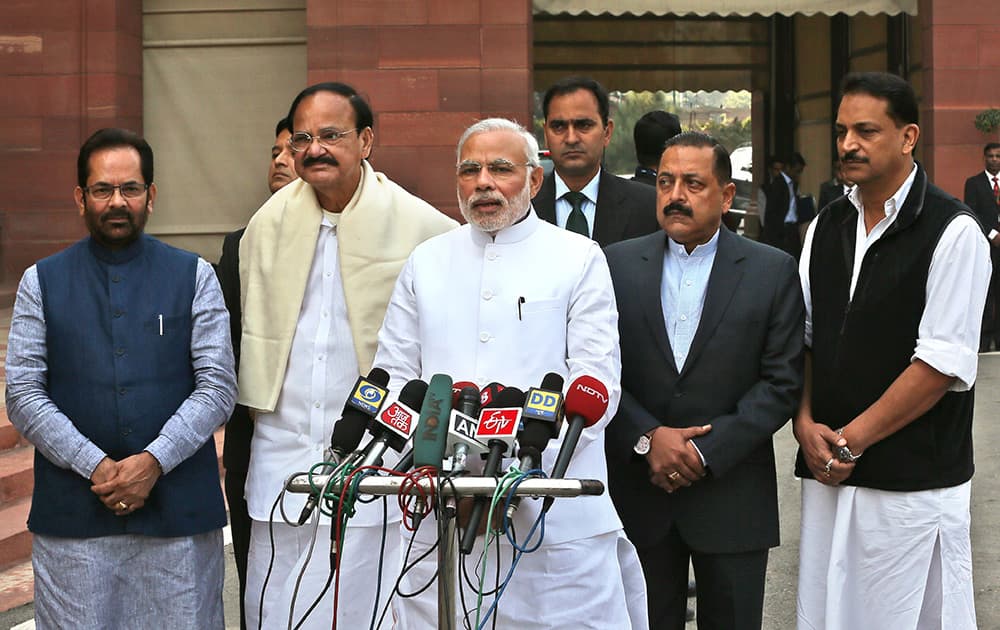 Prime Minister Narendra Modi, stands with his cabinet colleagues Mukhtar Abbas Naqvi, Venkaiah Naidu, Rajiv Pratap Rudy, right, Minister of State Dr. Jitendra Singh, as he addresses the media on the opening day of the winter session of the Indian parliament in New Delhi.