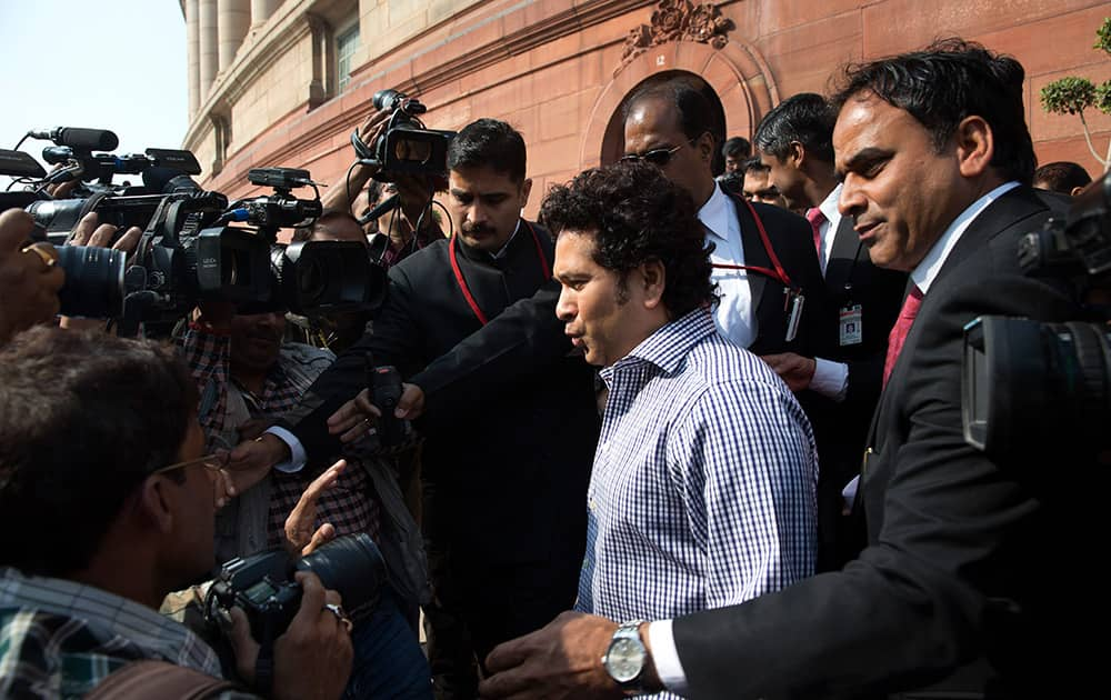 Sachin Tendulkar speaks to the media as he comes out of the parliament during the opening day of the winter session of the Indian parliament in New Delhi