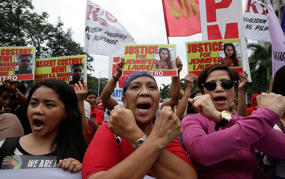 Protesters make cross signs as they shout slogans during a rally outside the U.S. Embassy in Manila, Philippines, to demand justice for the Oct. 11 killing of Filipino transgender Jennifer Laude at the former US naval base of Subic northwest of Manila. US Marine Pfc. Joseph Scott Pemberton was tagged as the suspect in the killing which the protesters termed as a 