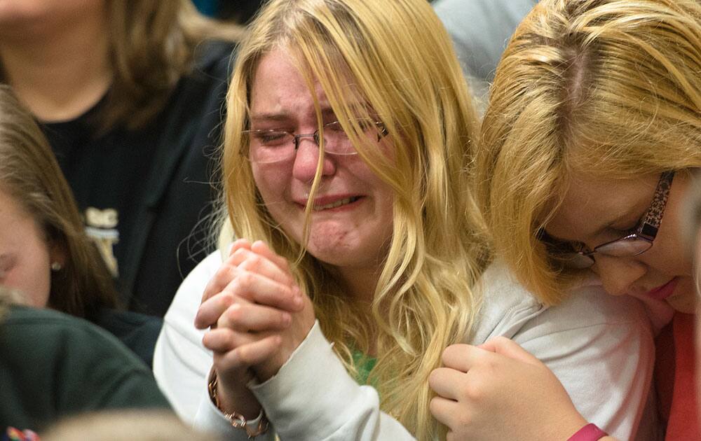Jennifer Hughes, right, senior, comforts Hannah Ertley, sophomore, during a prayer vigil at Wetumpka High School in Wetumpka, Ala., for three students killed in a car accident and one who was critically injured. 