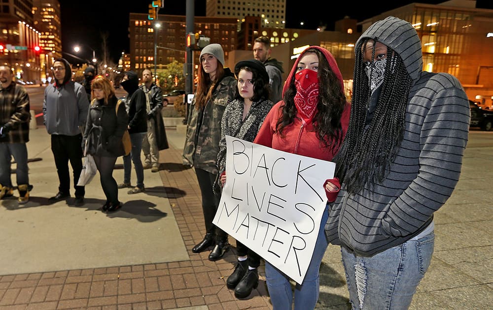 People protest outside the Wallace F Bennett Federal Building on the grand jury has decision not to indict Ferguson police officer Darren Wilson in the death of Michael Brown, in downtown Salt Lake City.