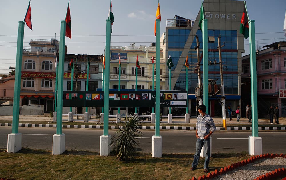 A Nepalese man looks at portraits of heads of South Asian Association for Regional Cooperation (SAARC), countries displayed on a road side in Katmandu, Nepal.