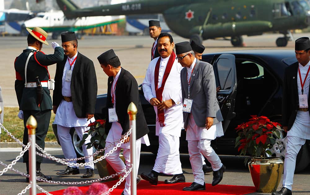 Sri Lankan President Mahinda Rajapaksa, center in white, arrives at the Tribhuwan Airport to attend the 18th summit of South Asian Association for Regional Cooperation (SAARC) in Katmandu, Nepal.