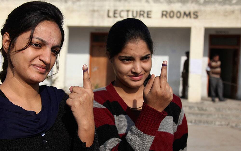 Young Kashmiri Hindus display the indelible ink mark on their fingers after casting their votes during the first phase of voting to the Jammu and Kashmir state assembly elections at Jagti, outskirts of Jammu, India.