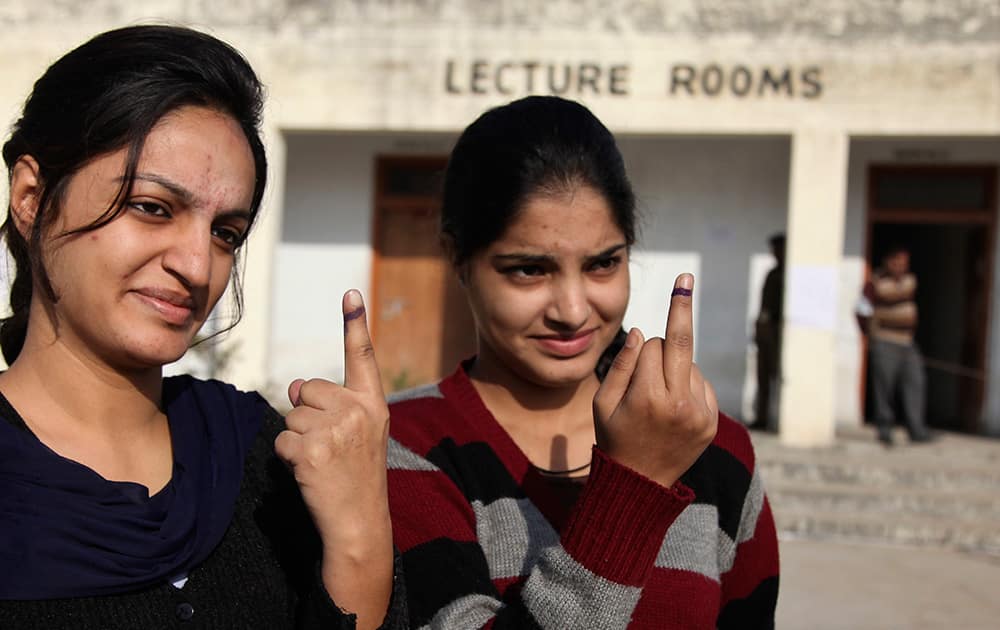 Young Kashmiri Hindus display the indelible ink mark on their fingers after casting their votes during the first phase of voting to the Jammu and Kashmir state assembly elections at Jagti, outskirts of Jammu.