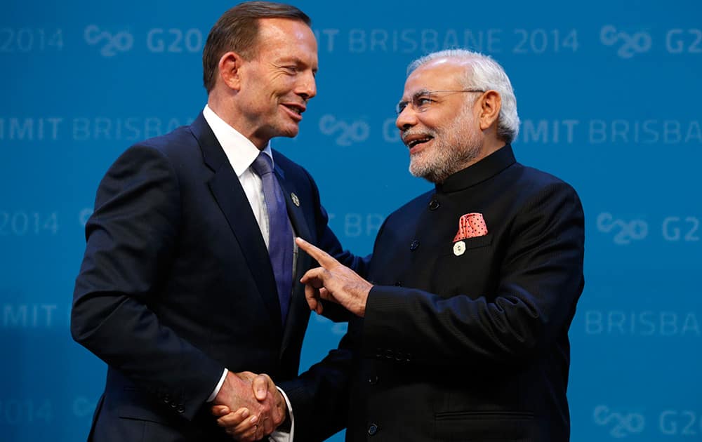 AUSTRALIAN PRIME MINISTER TONY ABBOTT GREETS INDIAN PRIME MINISTER NARENDRA MODI AT THE G20 IN BRISBANE, AUSTRALIA.