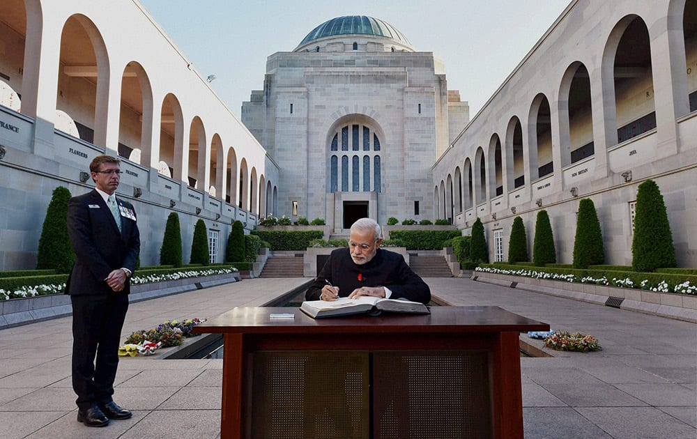 PRIME MINISTER NARENDRA MODI SIGNS VISITORS BOOK DURING A VISIT TO AUSTRALIAN WAR MEMORIAL.