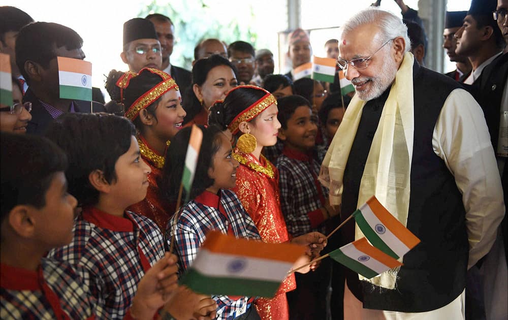 Prime Minister Narendra Modi being greeted by children as he arrives at a hotel in Kathmandu.