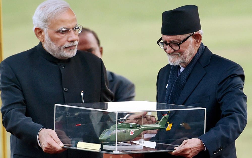 Prime Minister Narendra Modi presents the model of a chopper to his Nepali counterpart Sushil Koirala during the presentation ceremony of a chopper to Nepal army in Kathmandu.