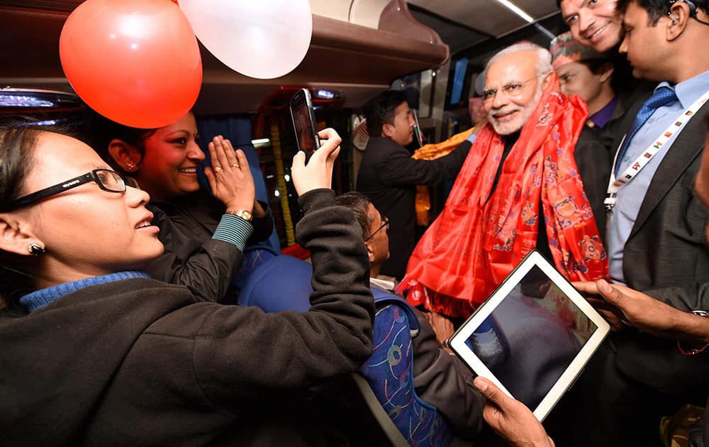 Prime Minister Narendra Modi interacts with people inside a bus prior to flagging off its maiden journey from Kathmandu to New Delhi, in Kathmandu.