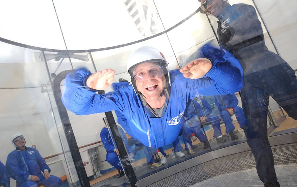 Scott Mayerowitz in the skydiving simulator aboard Royal Caribbean’s new Quantum of the Seas ship. Participants don special uniforms, earplugs, goggles and helmets, and float in the air on gusts from a powerful fan inside a giant wind tunnel. Instructors coach participants on how to move inside the tube.