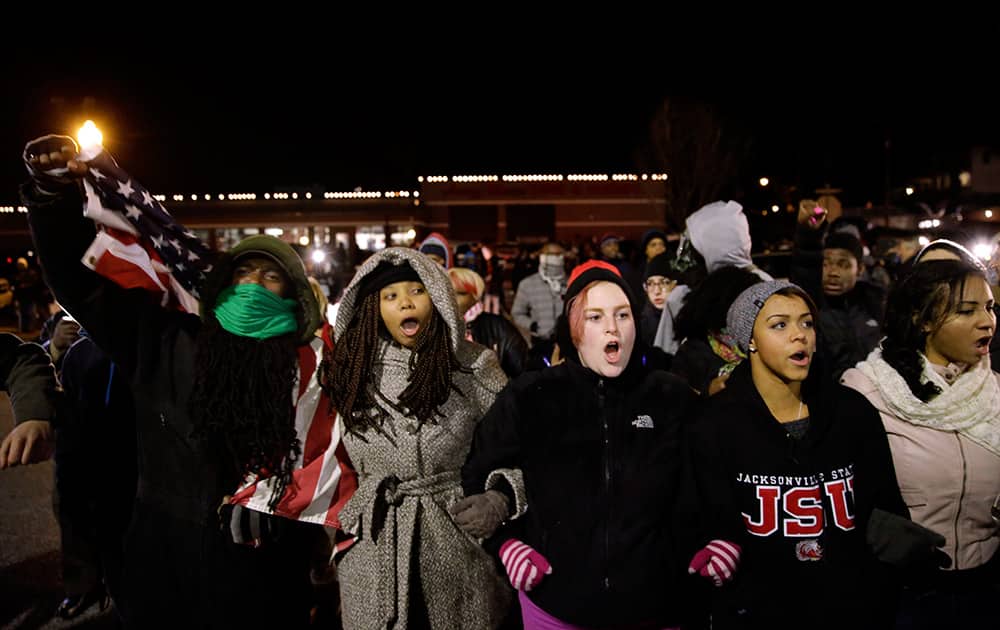 Protesters gather in front of the Ferguson Police Department, in Ferguson.