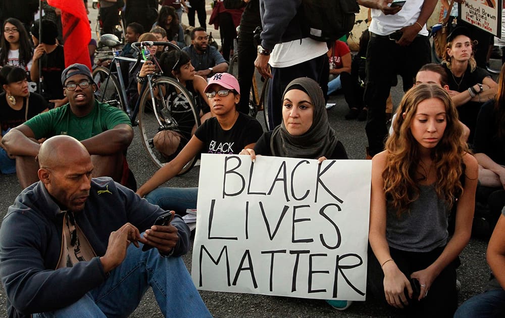 Protesters partake in a sit-in during a rally in Los Angeles, a day after the announcement that a grand jury decided not to indict Ferguson police officer Darren Wilson in the fatal shooting of Michael Brown.