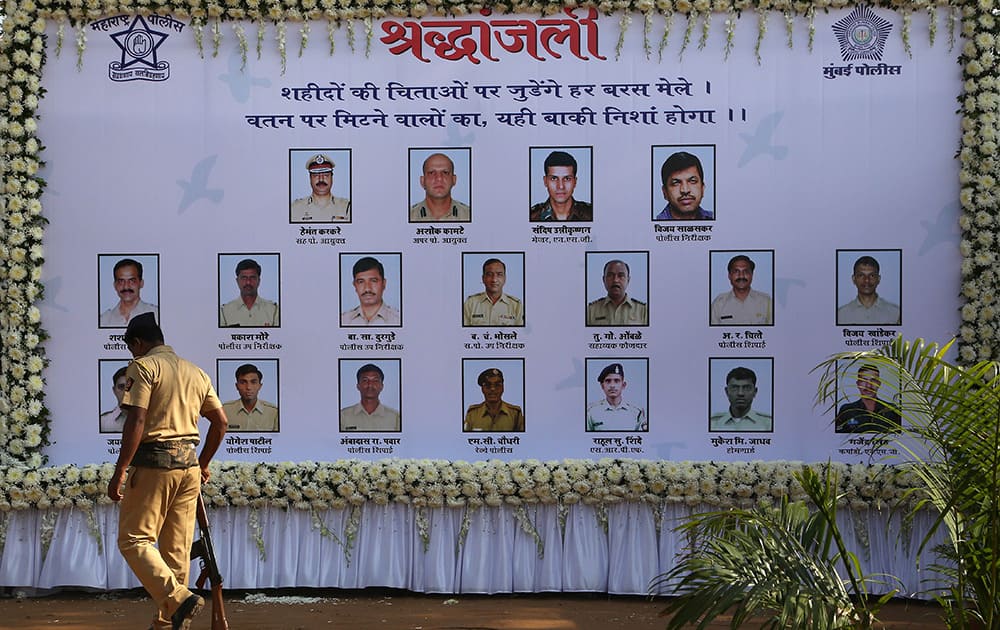 A policeman walks past a memorial in remembrance of those who died during the Mumbai attack, on the sixth anniversary of the attack in Mumbai.