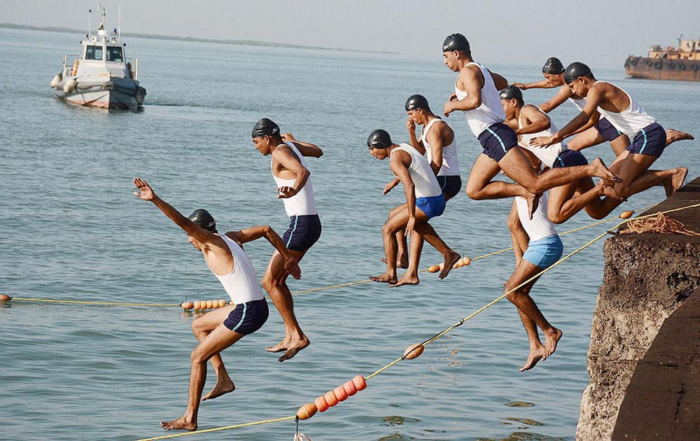 Officers of Indian Navy jump in Arabian sea for 100 meter swimming competitions as part of Navy Week celebrations in Jamnagar.