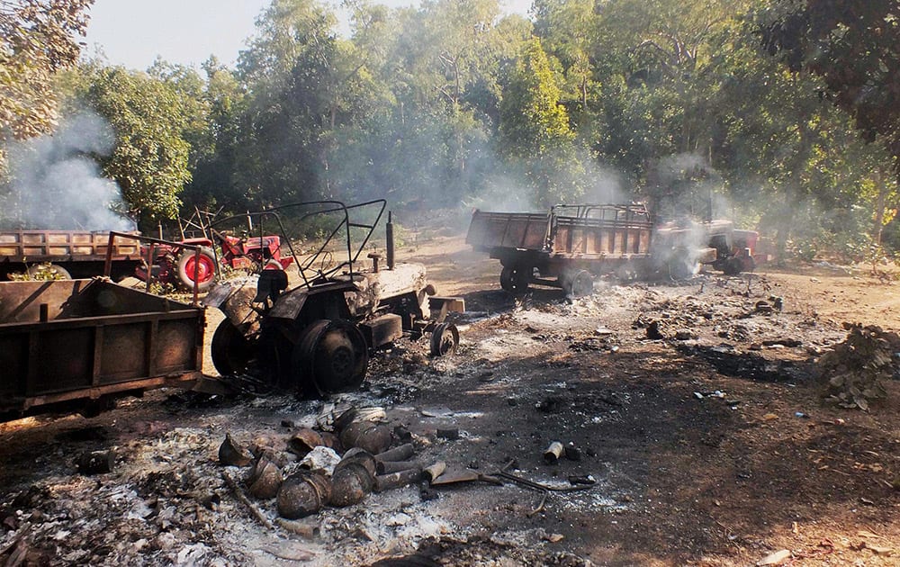 Tractors that were burnt after Maoist rebels attacked a polling party in Lai village in Latehar district.