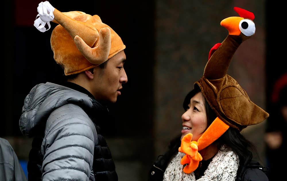 Tamari Hedani and her boyfriend, Chris Chu, both from San Francisco, wear turkey hats prior to the start of the Macy's Thanksgiving Day Parade, in New York.