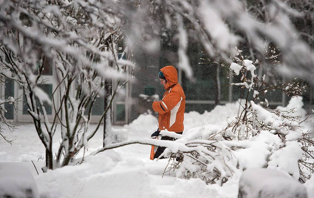 A pedestrian walks through the snow in Moncton, New Brunswick.