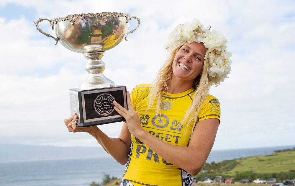 This photo provided by the Association of Surfing Professionals, Stephanie Gilmore, of Australia, poses with her ASP World Title trophy after winning the Target Maui Pro at Honolua Bay, Maui, Hawaii.