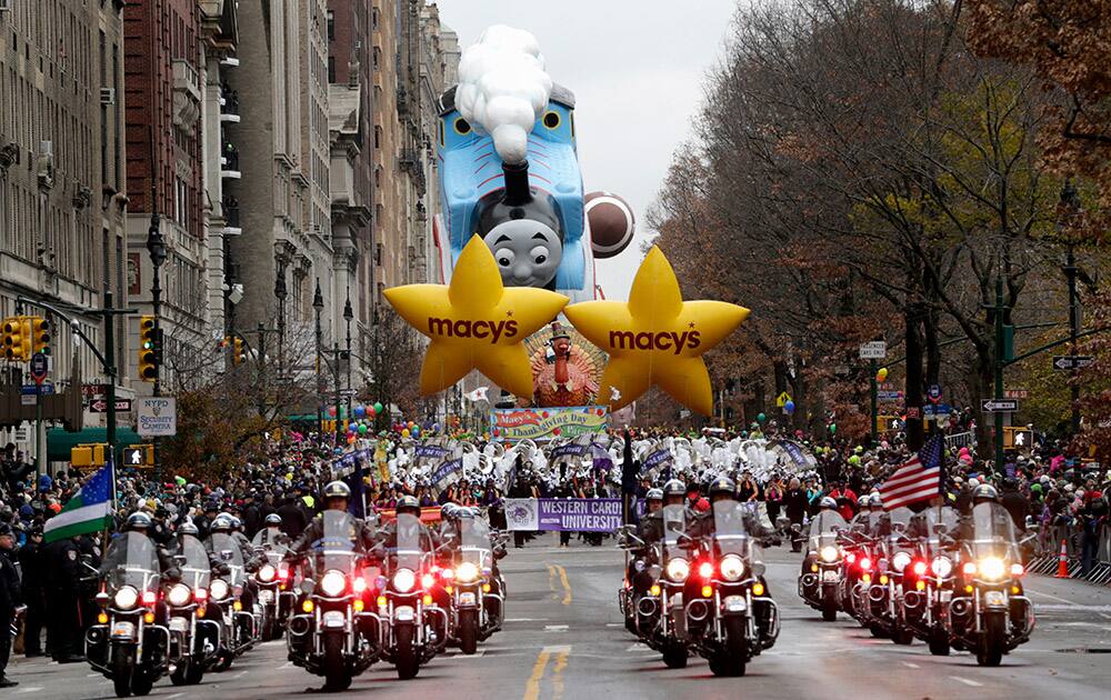 Police officers ride motorcycles while leading the start of the Macy's Thanksgiving Day Parade, in New York.