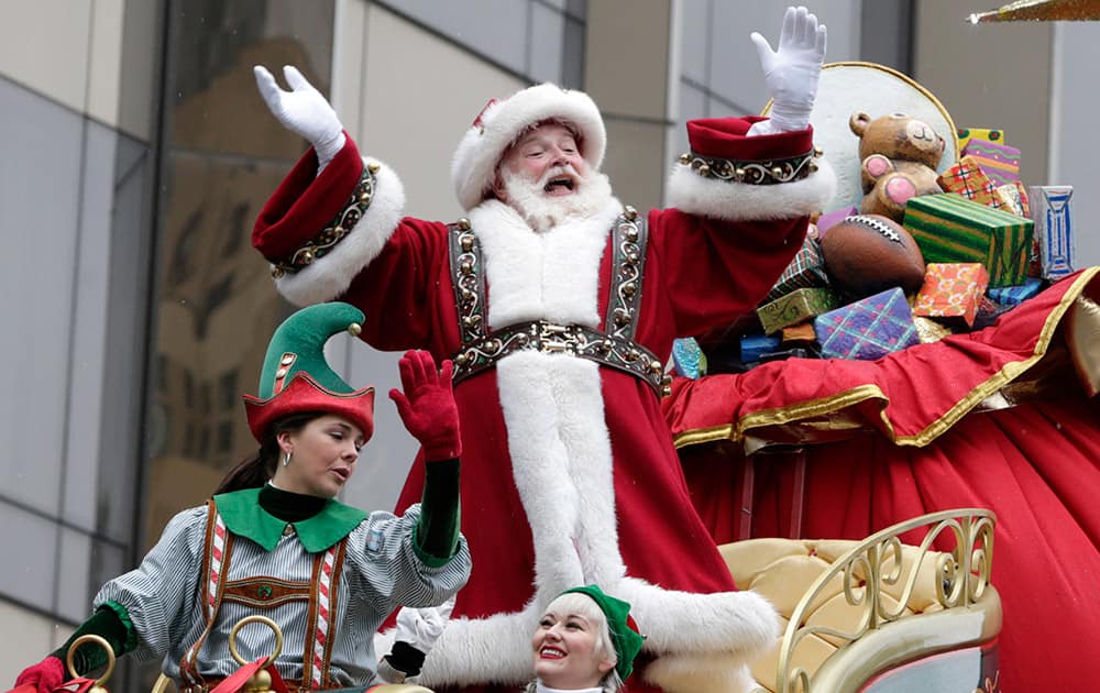 Santa Claus waves at the crowd during the Macy's Thanksgiving Day Parade, in New York.