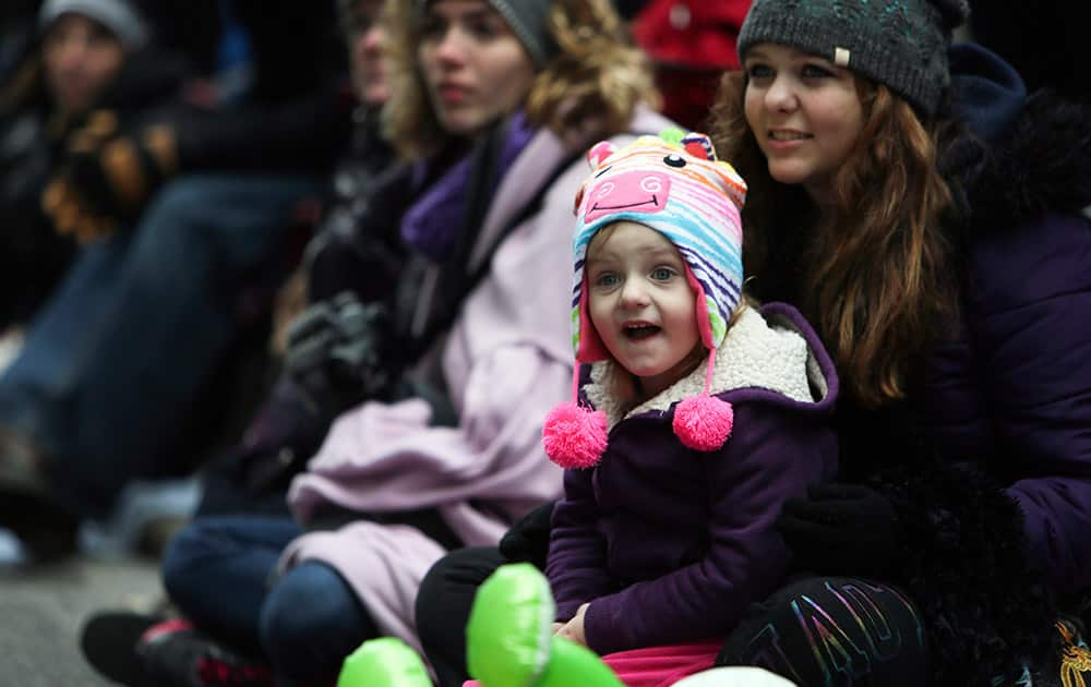 Hailey Dickson, 3, reacts while watching the 95th annual Thanksgiving day parade, in Philadelphia.