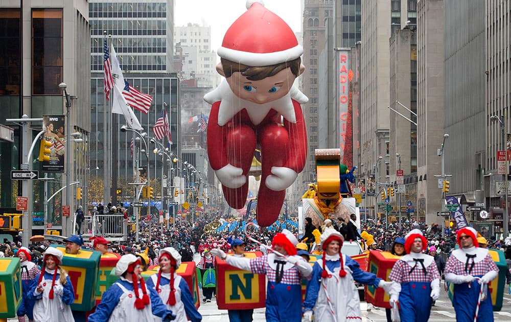 The Elf on the Shelf balloon is marched down Sixth Avenue during the Macy's Thanksgiving Day Parade, in New York.