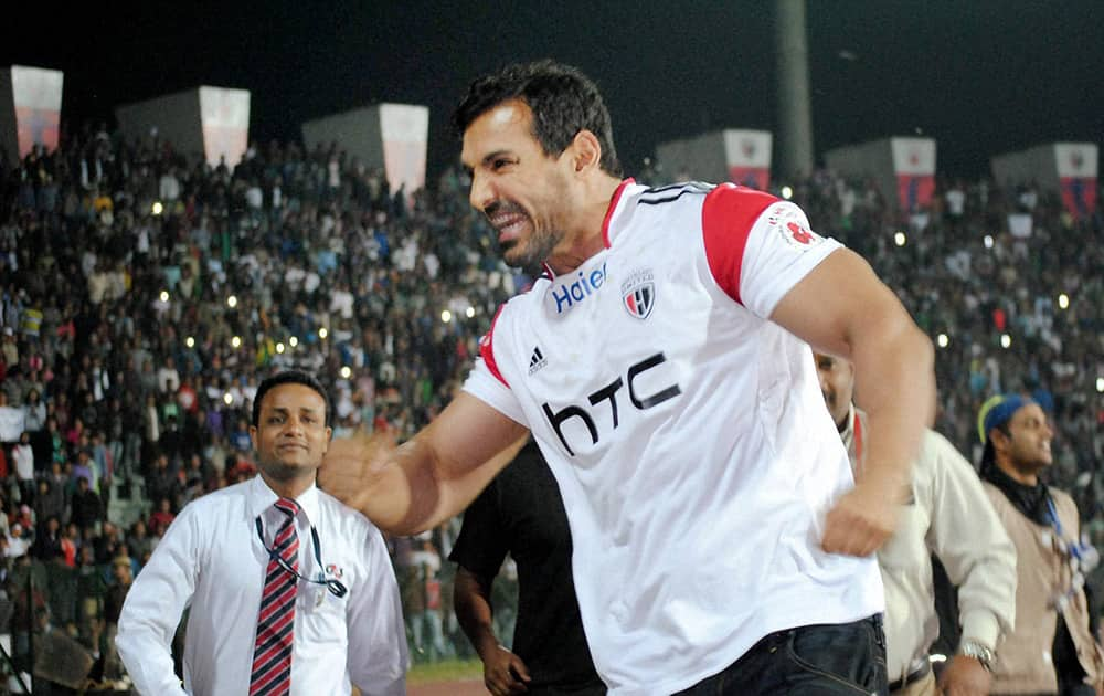 NorthEast United FC owner John Abraham celebrates after his teams third goal against Chennaiyin FC during their ISL match in Guwahati.