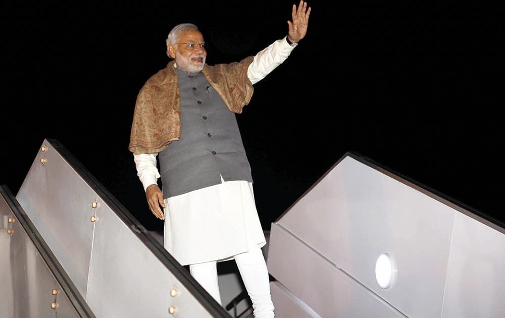 Prime Minister Narendra Modi waves on his departure from Kathmandu, Nepal.