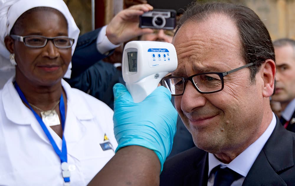 French President Francois Hollande has his temperature measured upon his arrival at the Donka hospital in Conakry, Guinea, as part of a one day visit in Guinea focused on Ebola situation.