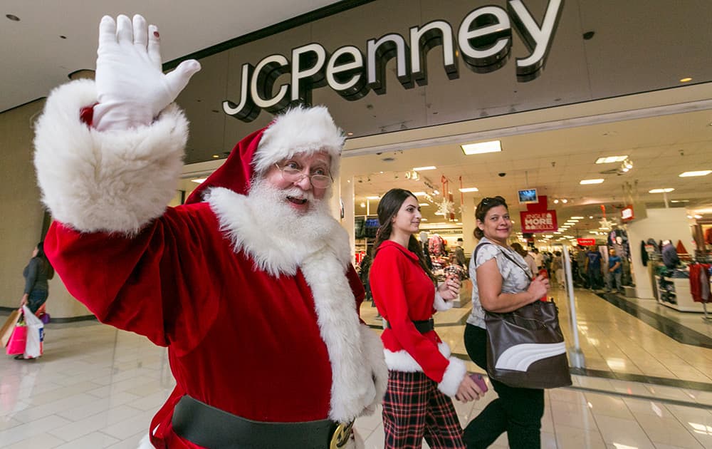 A man dressed as Santa Claus greets shoppers outside JCPenney store at the Glendale Galleria shopping mall in Glendale, Calif. Stores are welcoming a second wave of consumers in what has become a two-day kickoff to the holiday shopping season. 
