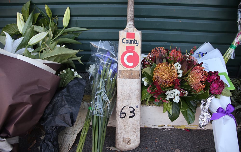 A bat is placed among floral tributes at the entrance to the Sydney Cricket Ground following the death of Australian cricket player Phil Hughes in Sydney.