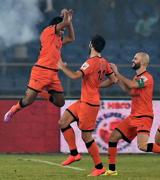 Delhi Dynamos FCs Manish Bhargav (L) celebrate with team mates after scoring their 4 goal against Mumbai City FC during the ISL 2014 match at Nehru Stadium in New Delhi.