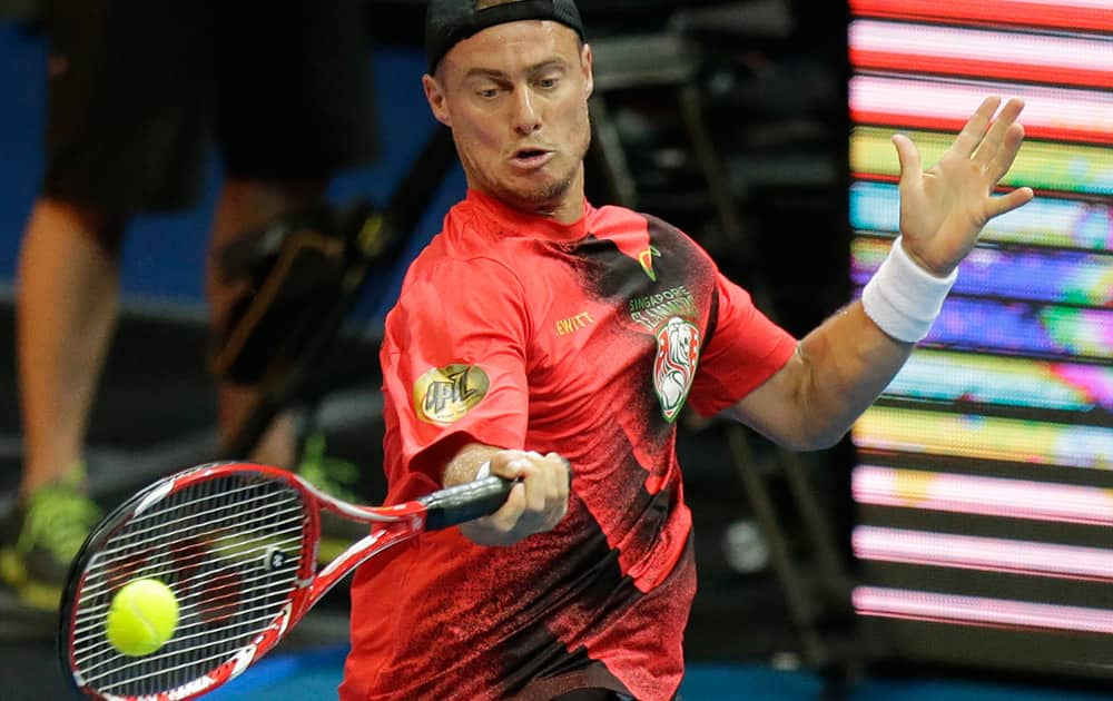 Lleyton Hewitt of Singapore Slammers return a serve from opponent Gael Monfils of the Indian Aces during their IPTL (International Premier Tennis League) singles match at the Mall of Asia Arena at suburban Pasay city, south of Manila, Philippines. 