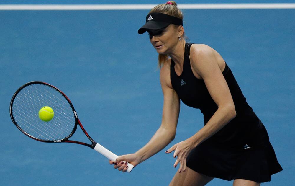 Daniela Hantuchova of the Singapore Slammers returns a shot from opponent Ana Ivanovic of the Indian Aces during their IPTL (International Premier Tennis League) singles match at the Mall of Asia Arena at suburban Pasay city, south of Manila, Philippines.