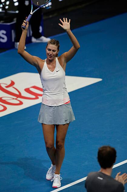 Maria Sharapova of the Manila Mavericks gestures as she celebrates her win over Kristina Mladenovic of the UAE Royals in their IPTL (International Premier Tennis League) Women's Singles match at the Mall of Asia Arena at suburban Pasay city, south of Manila, Philippines.