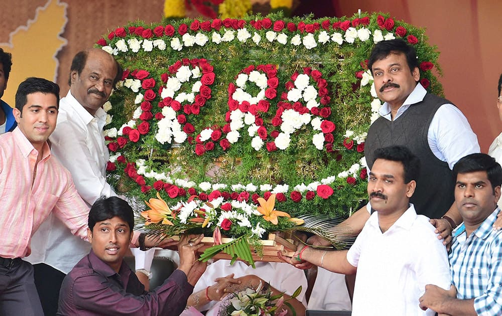 Super Star Rajnikant and Mega Star Chiranjivi being given a floral board during the inauguration of Dr Rajkumars Memorial.