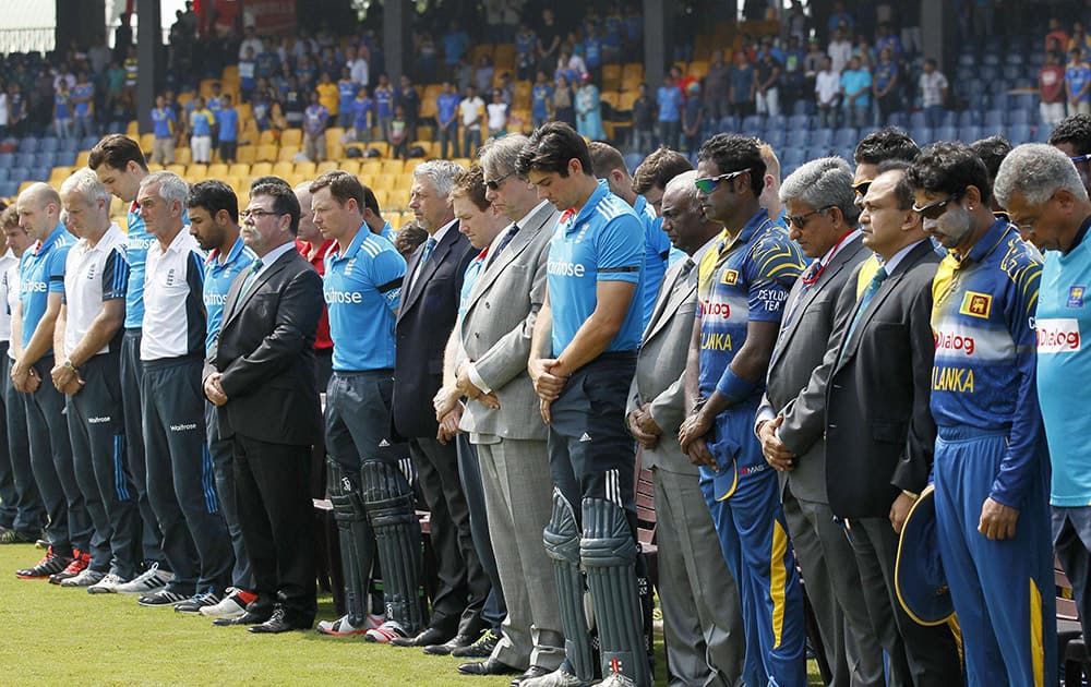 Sri Lankan and England cricket team members and officials observe a minute silence in memory of Australian cricketer Phil Hughes during the second one day international cricket match between Sri Lanka and England in Colombo, Sri Lanka.