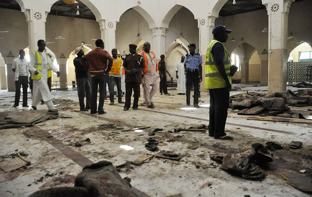 People inspect the central mosque following a bomb explosion in Kano, Nigeria. More than 102 people were killed in the bomb explosions at the central mosque in Kano, said a hospital worker. 
