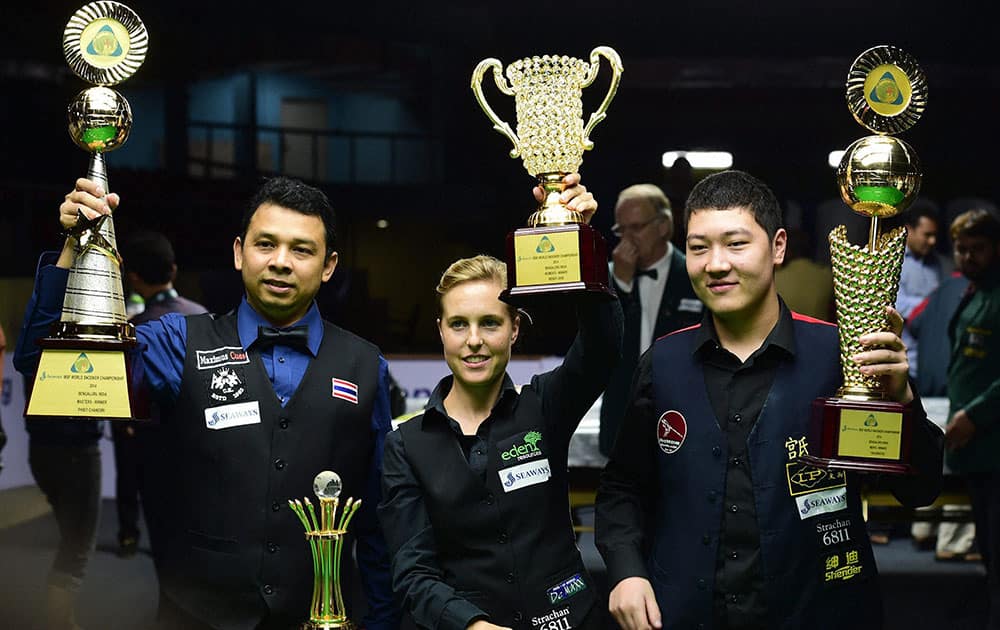 Chinese Cueist Yan Bingtao (R) Mens category, Wendy Jans (C) Women category and Masters Phisit Chandsri (L) with their trophies during the award ceremony of World Snooker Championship 2014 at Kanteerava stadium in Bengaluru.