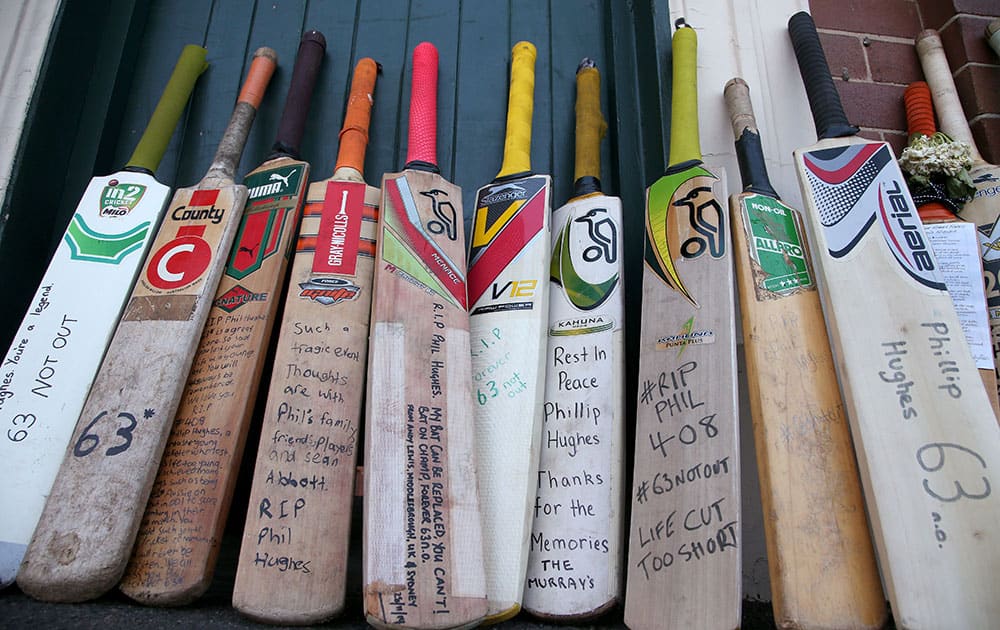 A row of bats with messages are lined up as a tribute for Phillip Hughes at the Sydney Cricket Ground in Sydney.