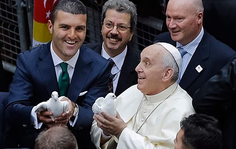 Pope Francis releases a white dove outside the Catholic Cathedral of the Holy Spirit in Istanbul, before concelebrating a mixed-rite Mass. 