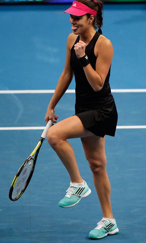 Ana Ivanovic of the Indian Aces team sticks out her tongue after winning a point against Maria Sharapova of the Manila Mavericks, during the women's singles match in the International Premier Tennis League at the Mall of Asia Arena at suburban Pasay city, south of Manila, Philippines.