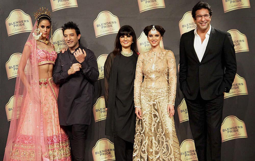 Bollywood actor Aditi Rao Hydari, former Pakistani cricketer Wasim Akram, and designers Neeta Lulla and Suneet Varma at a fashion show in Mumbai.