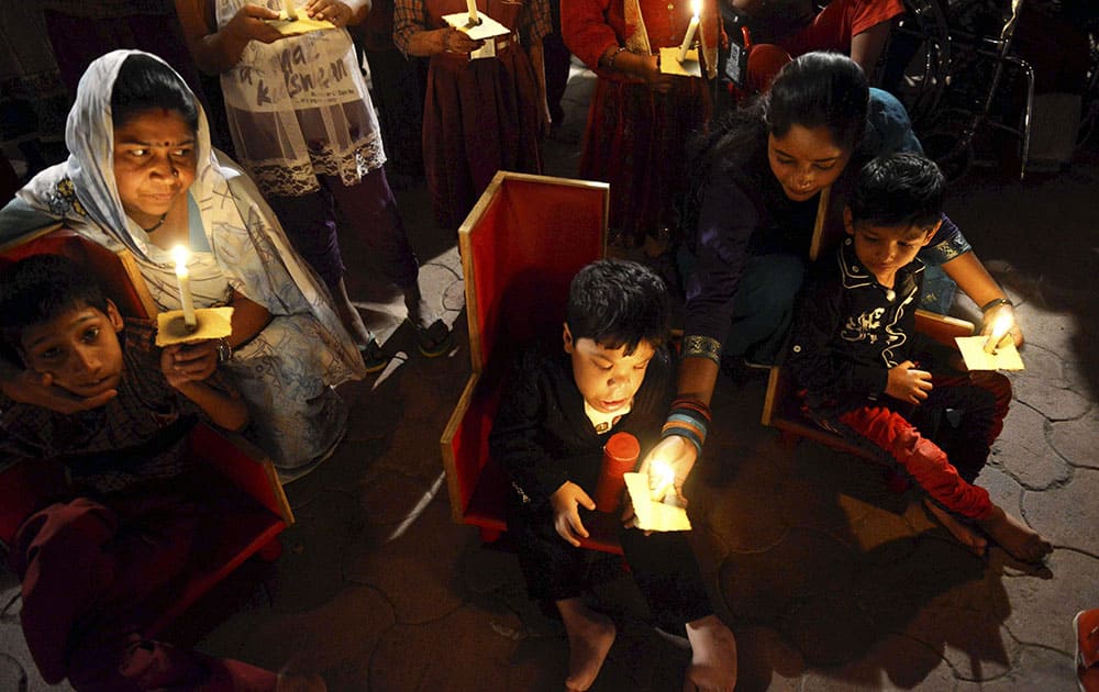 Victims of the Bhopal Gas Tragedy take part in a candle lit vigil to mark the 30th anniversary of the tragedy in Bhopal.