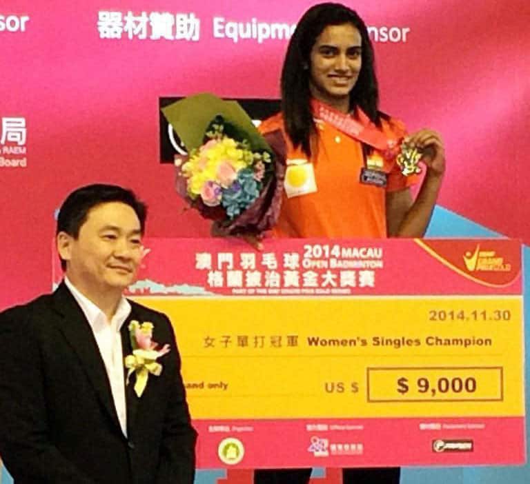 Badminton player PV Sindhu poses with her medal and cheque after claiming victory in the Womens Singles Final at the Macau Open. 