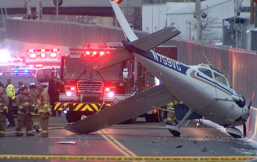 This photo provided by NBC Connecticut News shows the single engine plane that landed on a bus-only roadway in West Hartford, Conn.